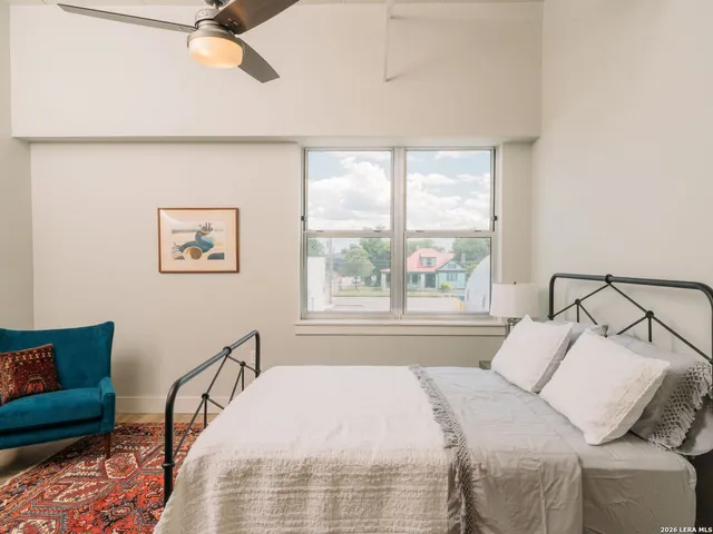 a bed sitting in a bedroom next to a window
