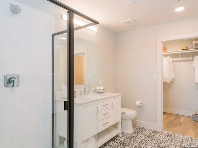 a bathroom with a toilet a sink and a mirror
