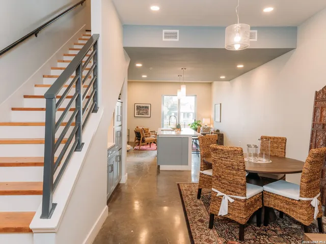 a dining room with furniture and a chandelier