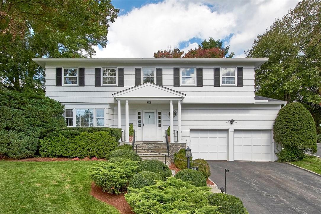 188 Country Ridge Drive Rye Brook, NY 10573 - Photo 1 of 1 a front view of a house with a yard and garage