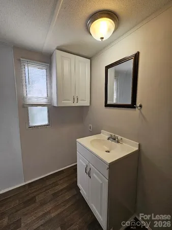 a view of a bathroom with a sink and a mirror