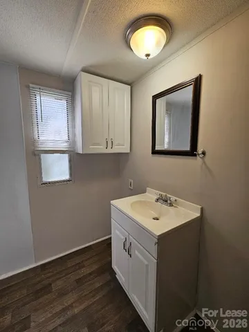 a view of a bathroom with a sink and a mirror