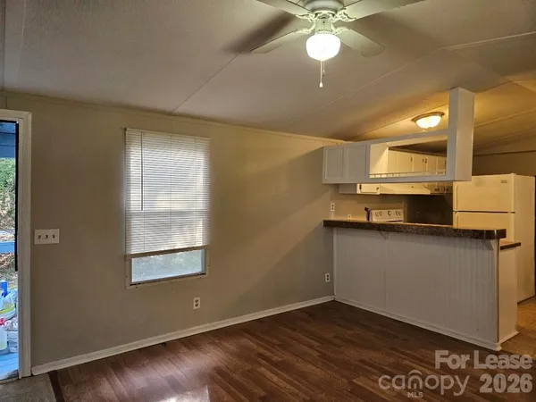 a living room with a couch and a ceiling fan