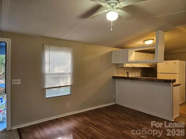 a living room with a couch and a ceiling fan