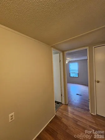 a view of hallway with wooden floor