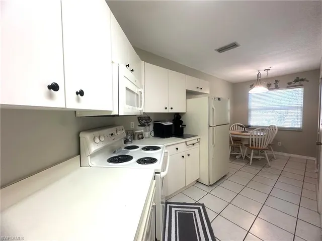 a kitchen with a sink a stove a refrigerator and cabinets
