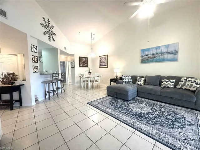 a living room with furniture and a dining table