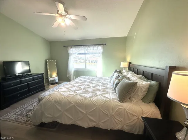 a bedroom with a bed and a television