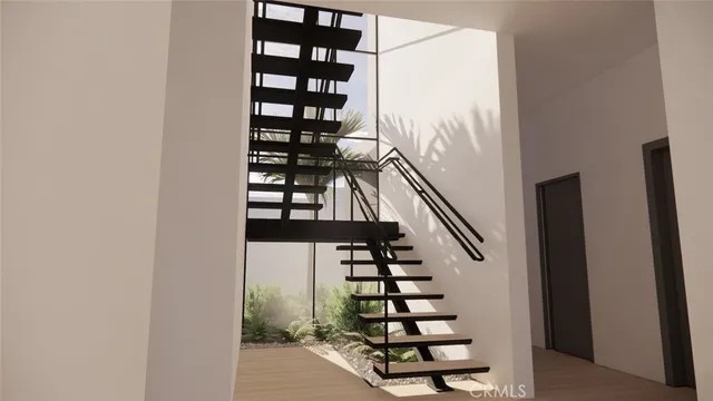 a view of entryway with stairs and wooden floor