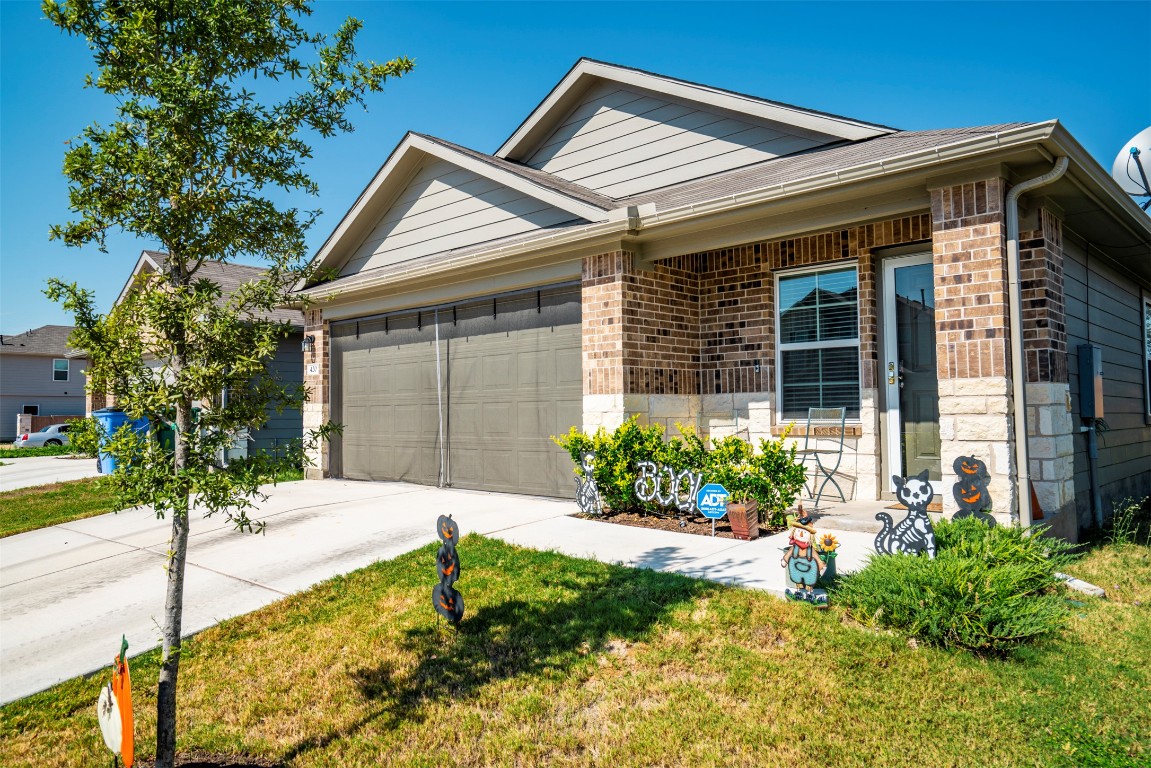 420 Sickle Loop Kyle, TX 78640 - Photo 1 of 28 a front view of a house with garden