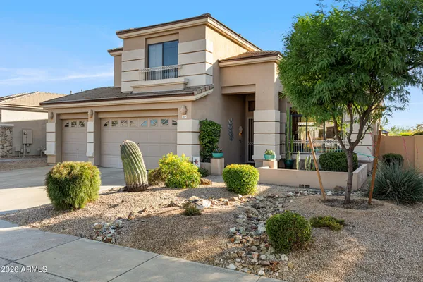a view of a house with potted plants