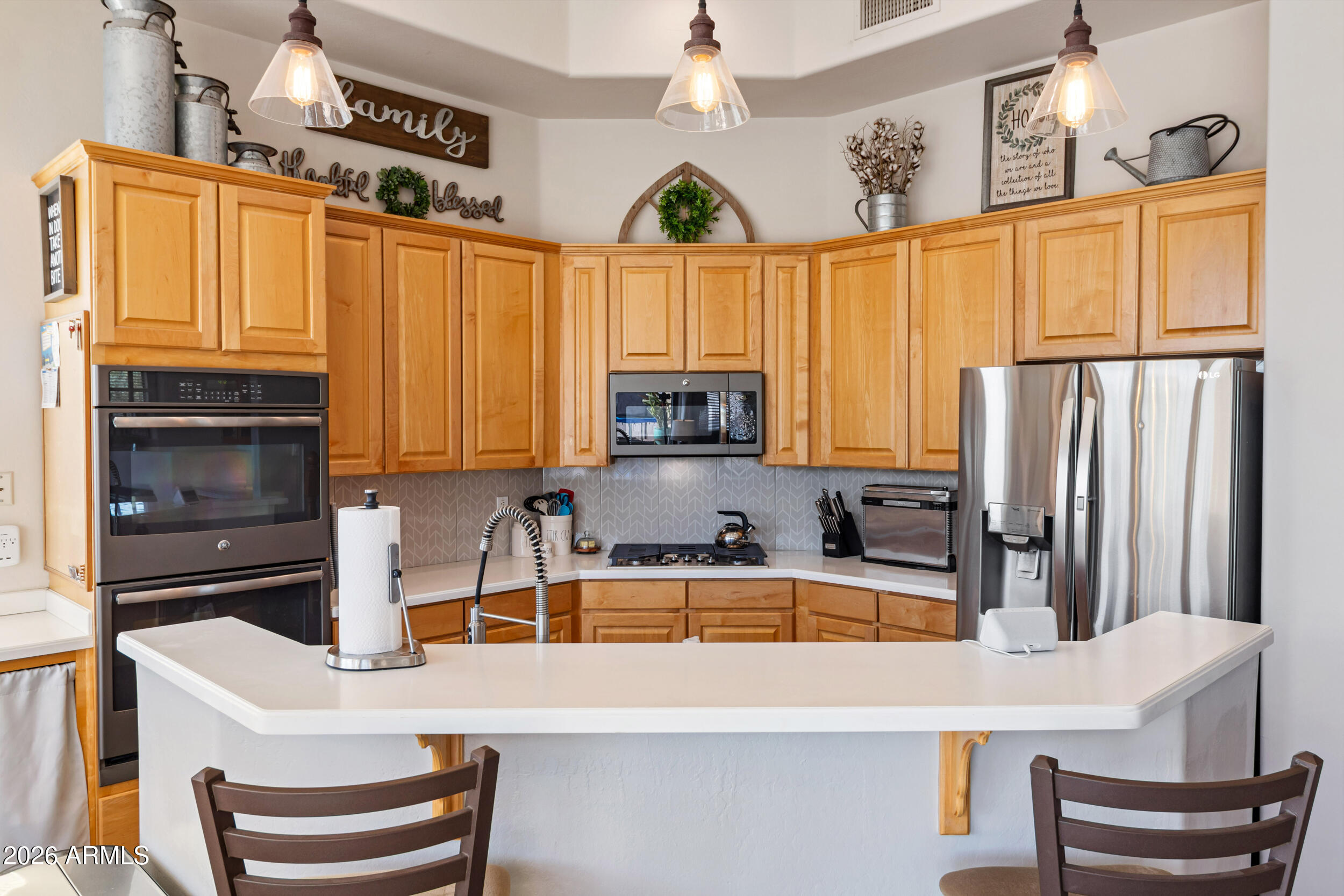 5219 East Hashknife Road Phoenix, AZ 85054 - Photo 12 of 38 a kitchen with granite countertop a sink and a refrigerator