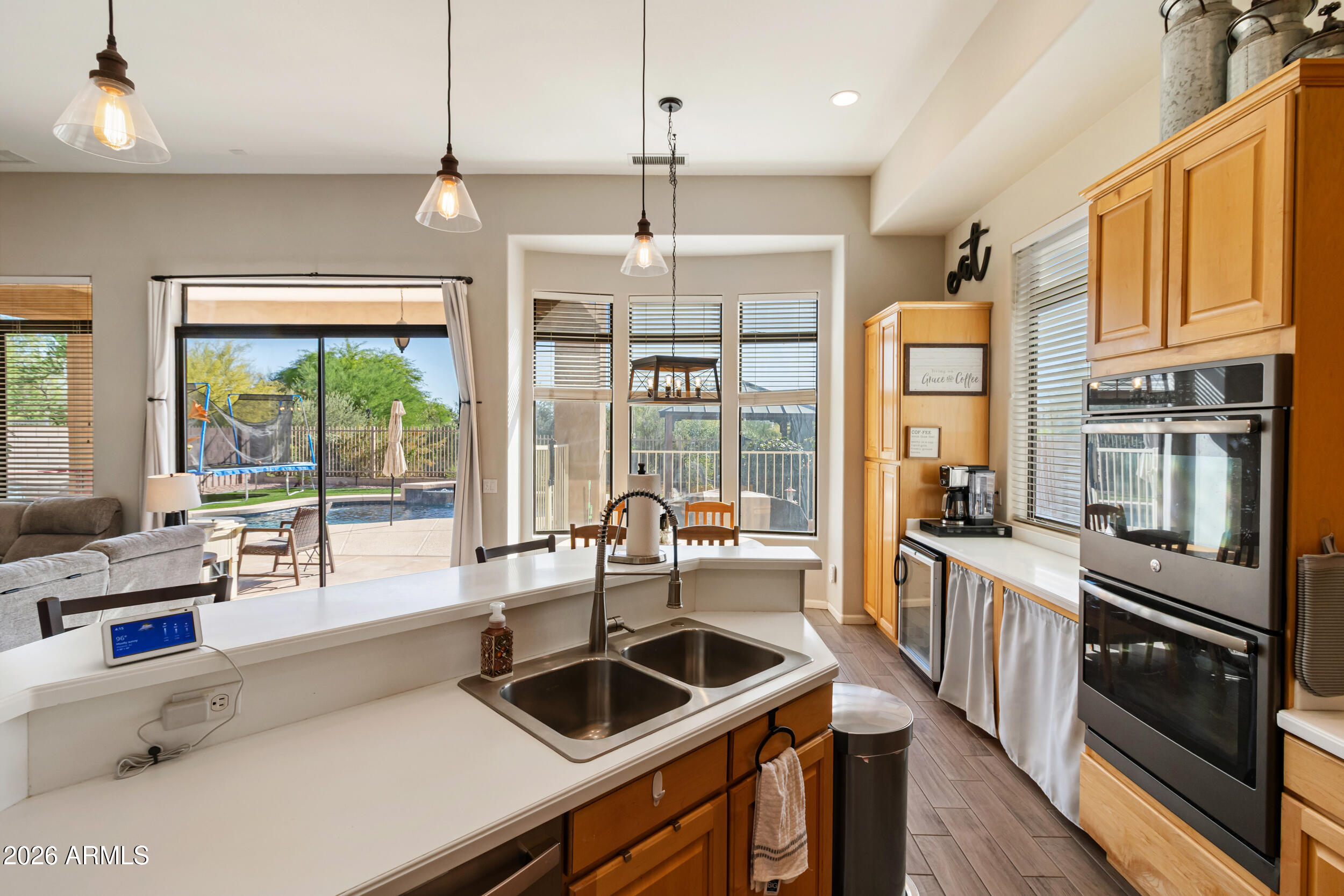 5219 East Hashknife Road Phoenix, AZ 85054 - Photo 13 of 38 a kitchen with stainless steel appliances a stove a sink and a refrigerator