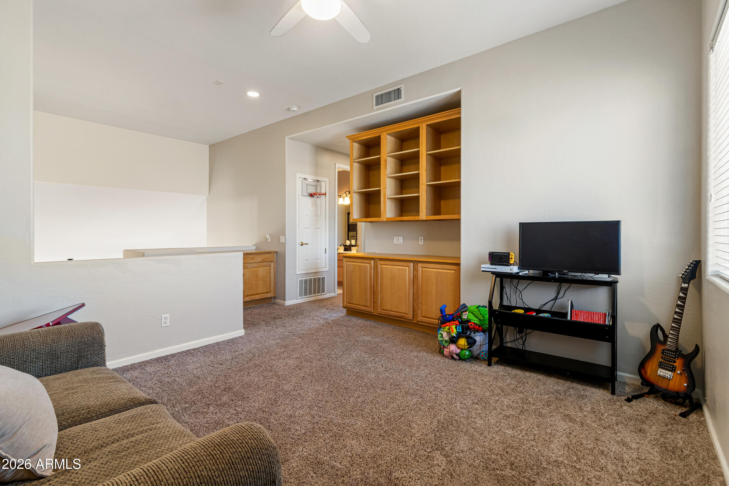 5219 East Hashknife Road Phoenix, AZ 85054 - Photo 18 of 38 a living room with furniture and a flat screen tv