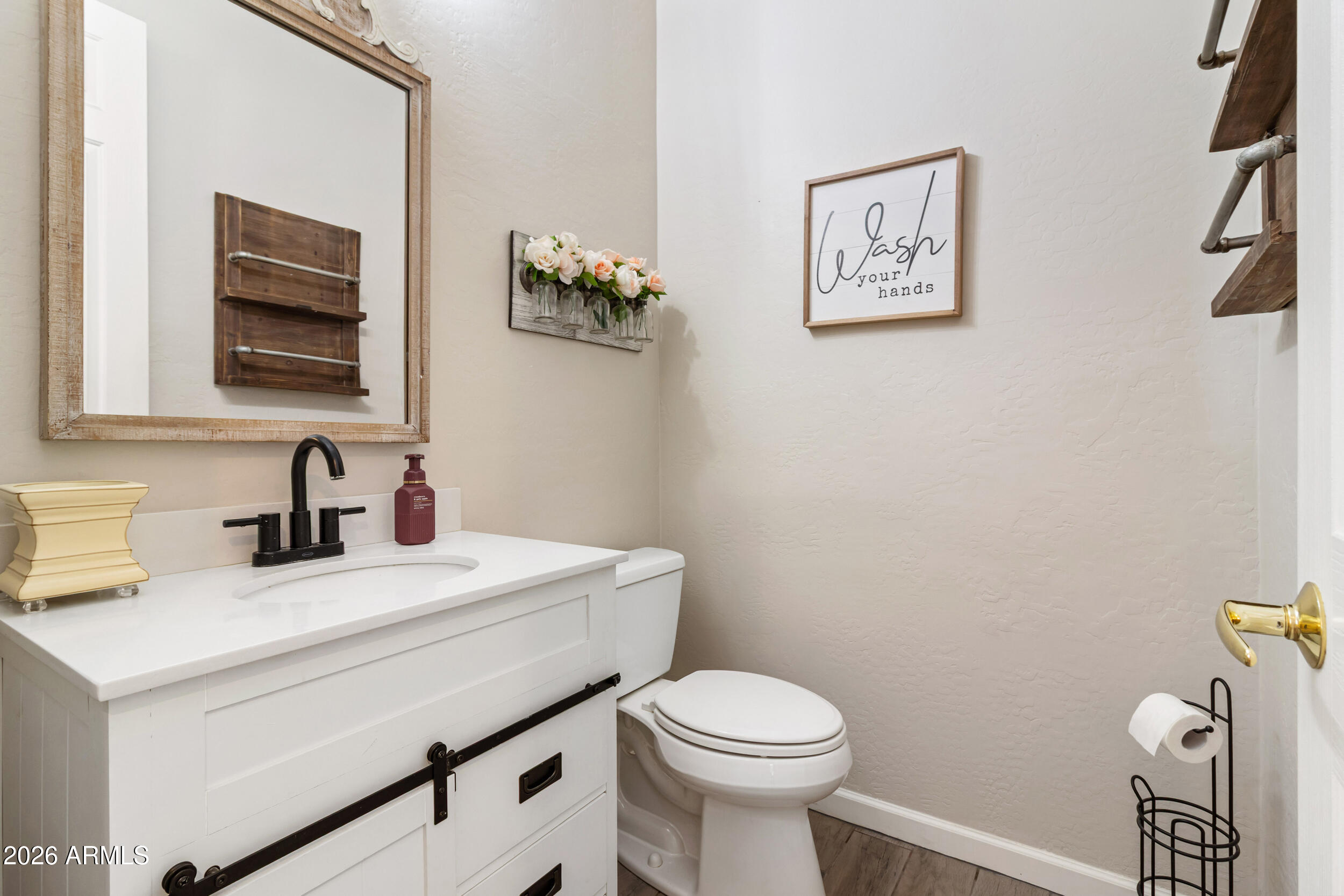 5219 East Hashknife Road Phoenix, AZ 85054 - Photo 19 of 38 a bathroom with a toilet a sink and mirror