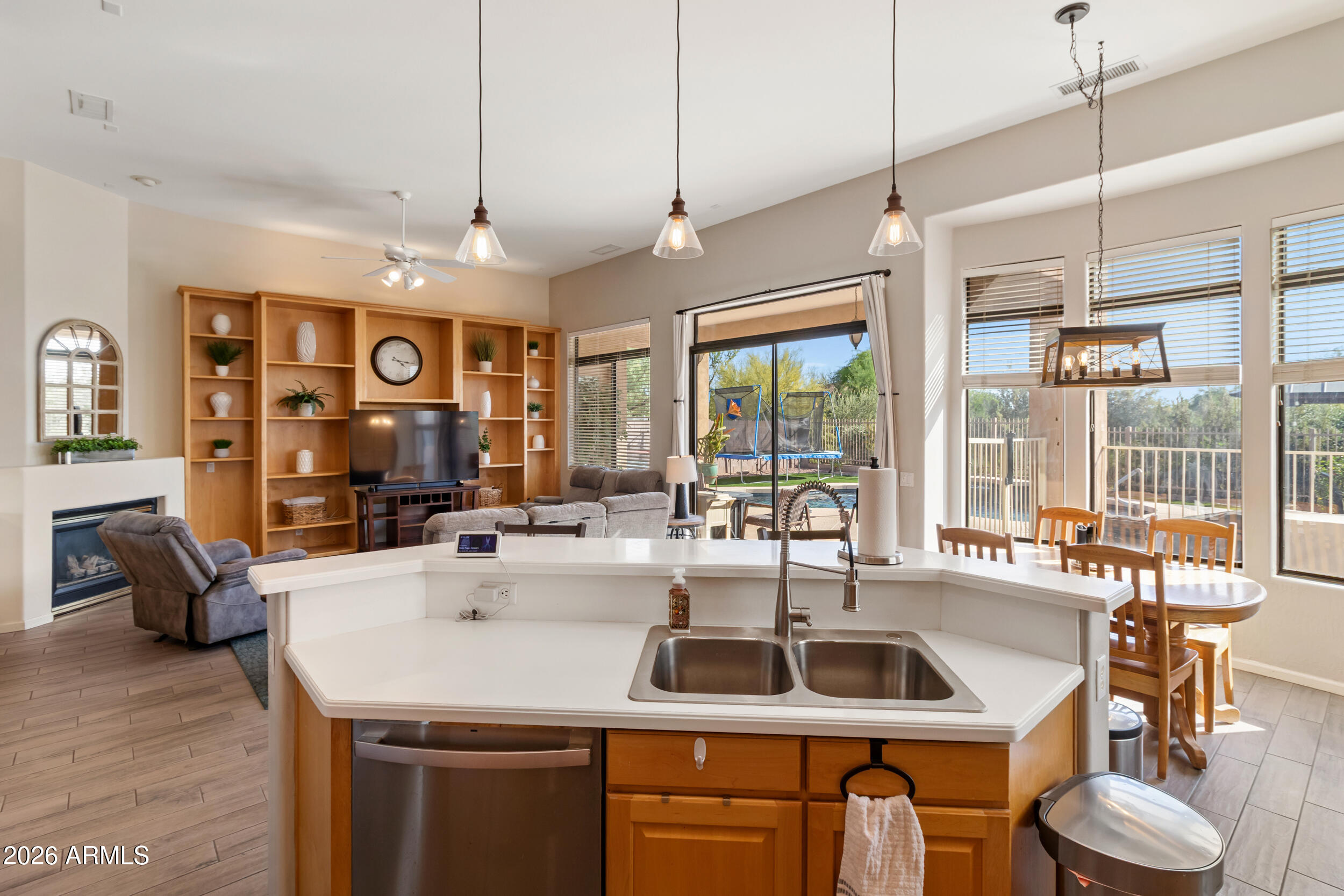 5219 East Hashknife Road Phoenix, AZ 85054 - Photo 2 of 38 a kitchen with a sink a counter and living room view
