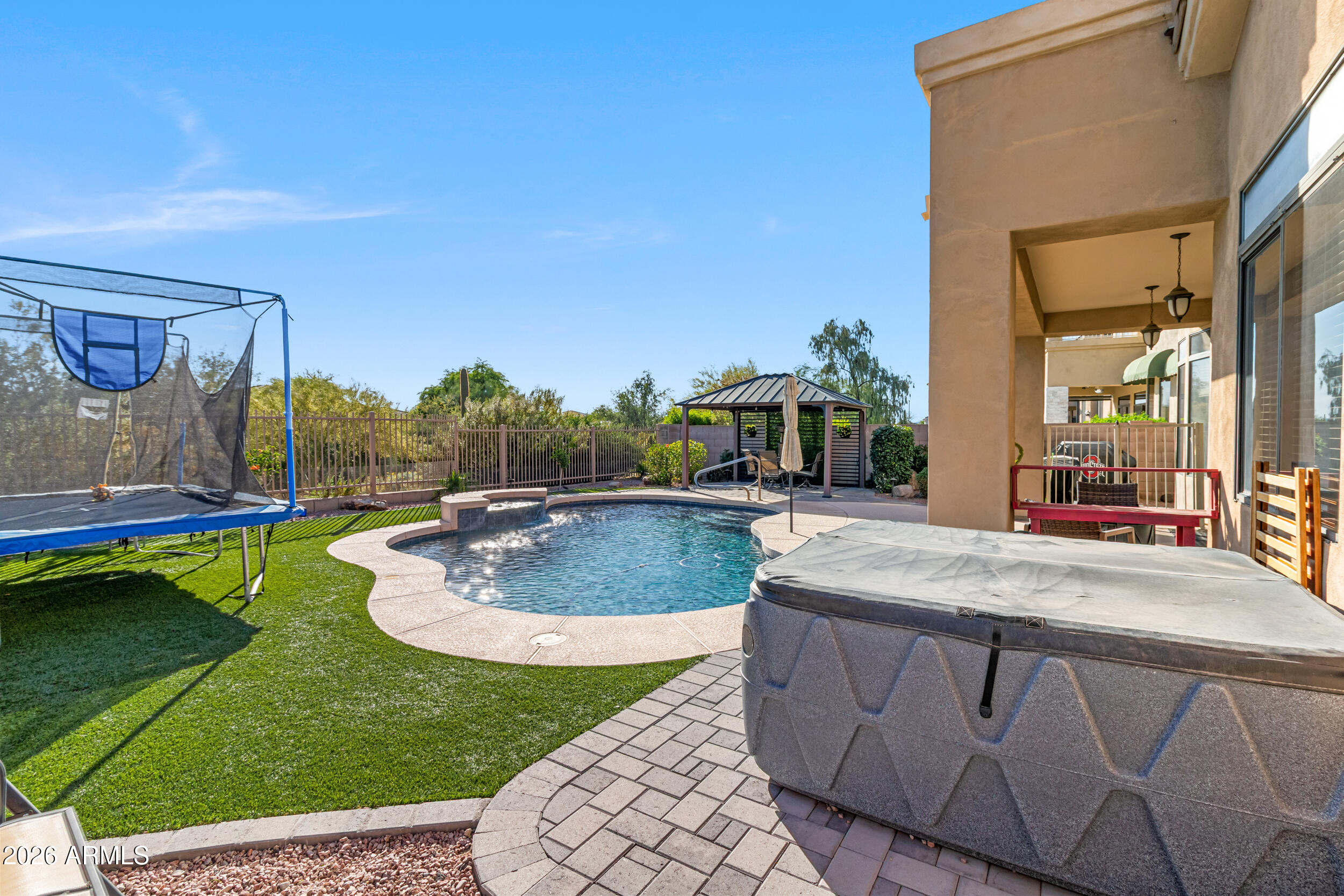 5219 East Hashknife Road Phoenix, AZ 85054 - Photo 24 of 38 a swimming pool with outdoor seating and yard