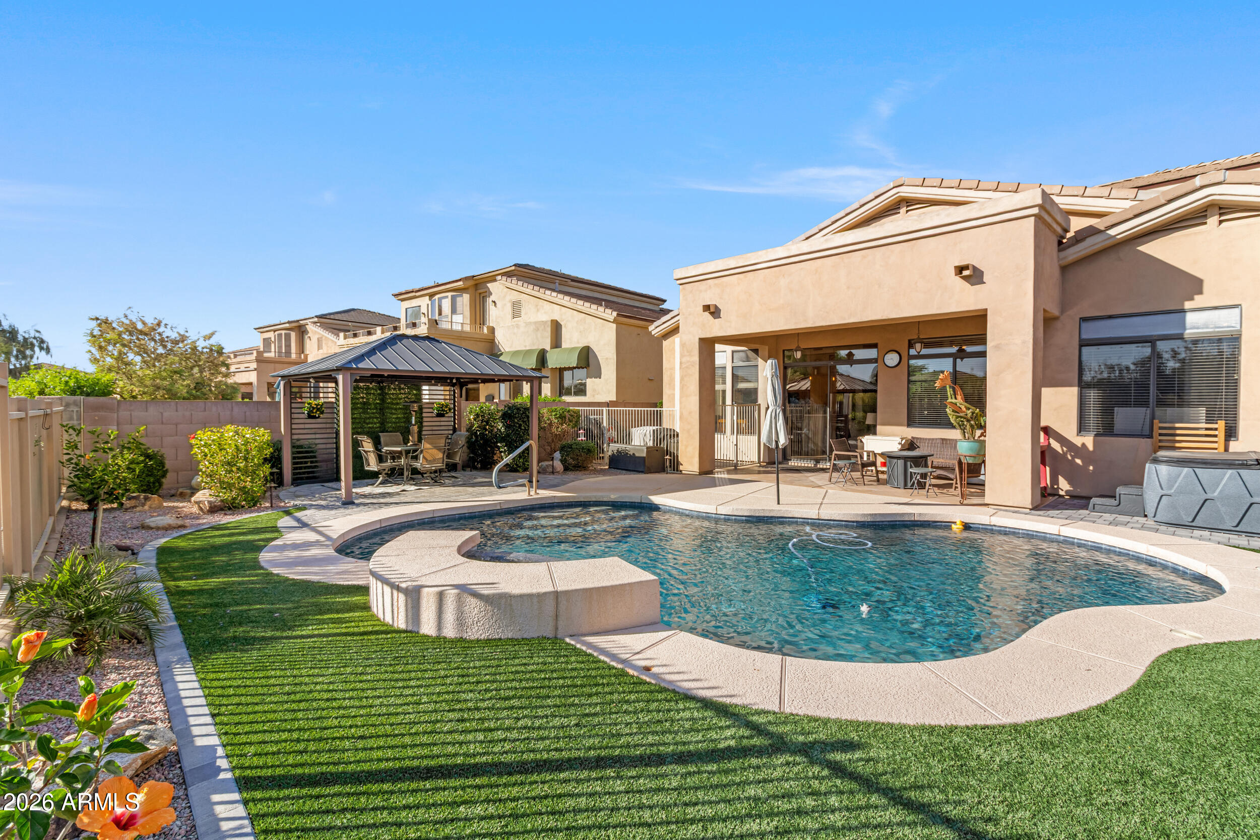 5219 East Hashknife Road Phoenix, AZ 85054 - Photo 25 of 38 a view of a house with swimming pool and sitting area