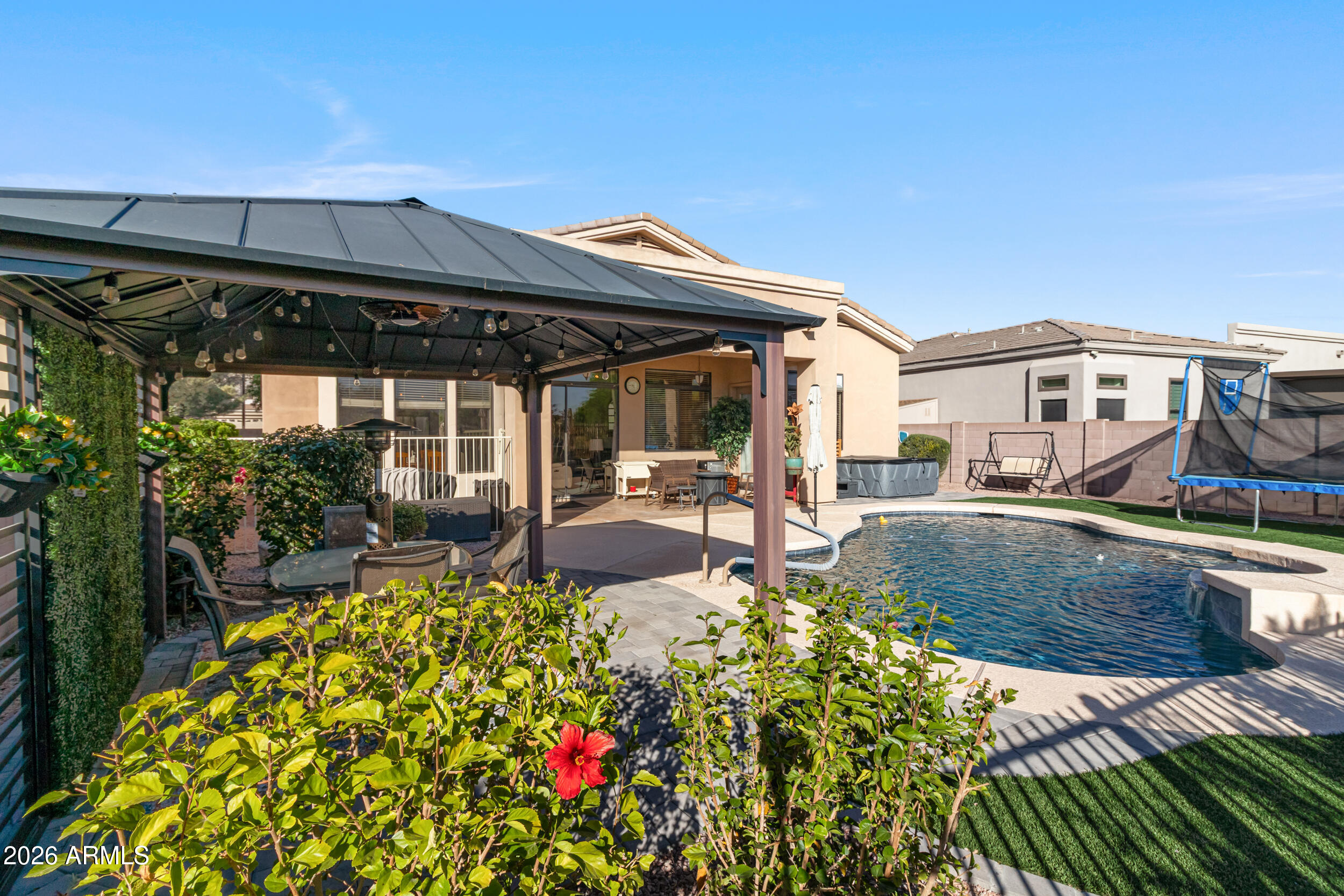5219 East Hashknife Road Phoenix, AZ 85054 - Photo 26 of 38 a view of a house with swimming pool and sitting area