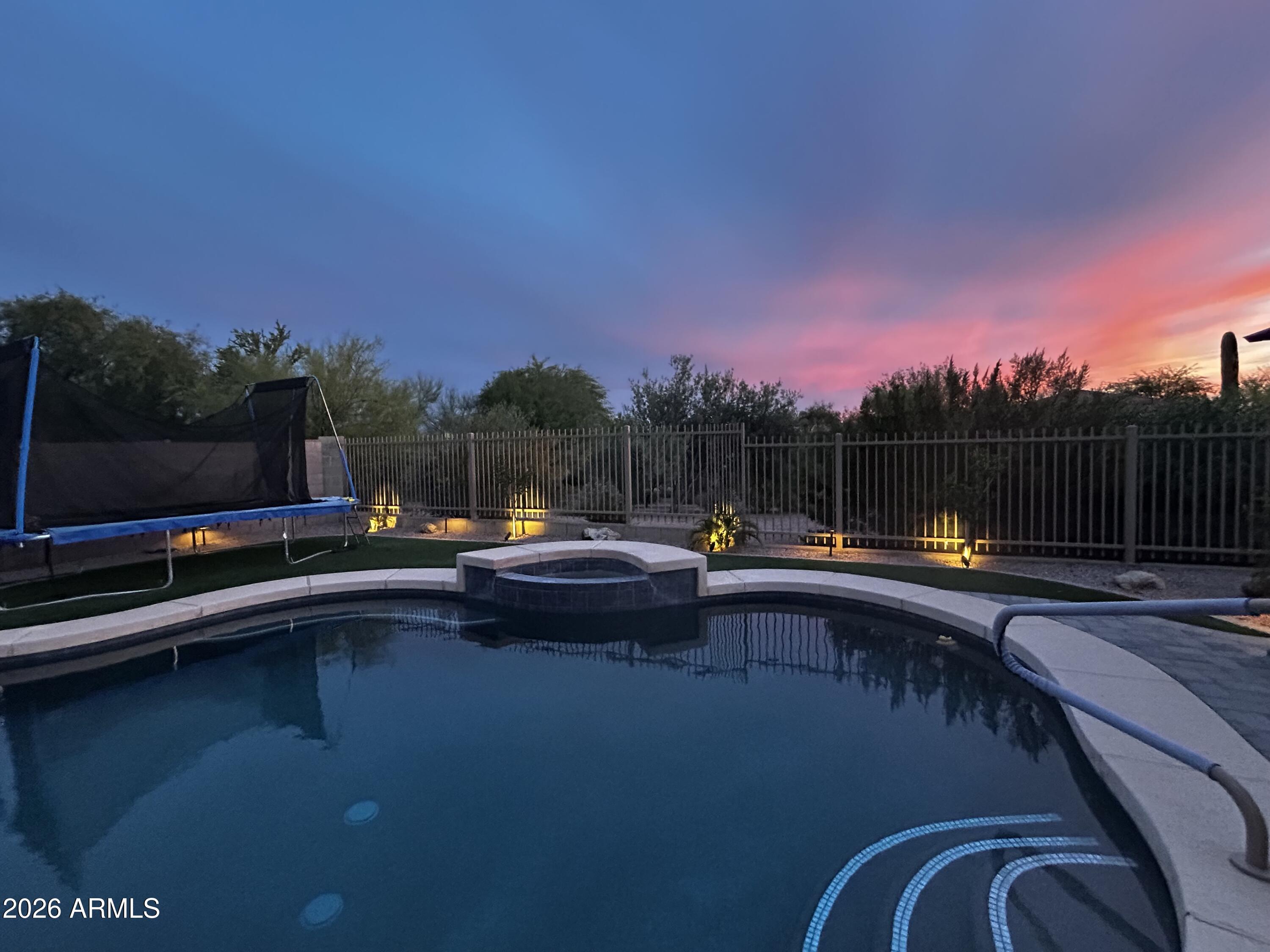 5219 East Hashknife Road Phoenix, AZ 85054 - Photo 28 of 38 a view of swimming pool with a bench in a lake