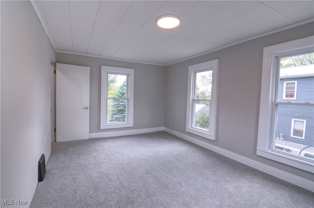12341 Portage Street Rittman, OH 44270 - Photo 14 of 23 Empty room featuring plenty of natural light and carpet