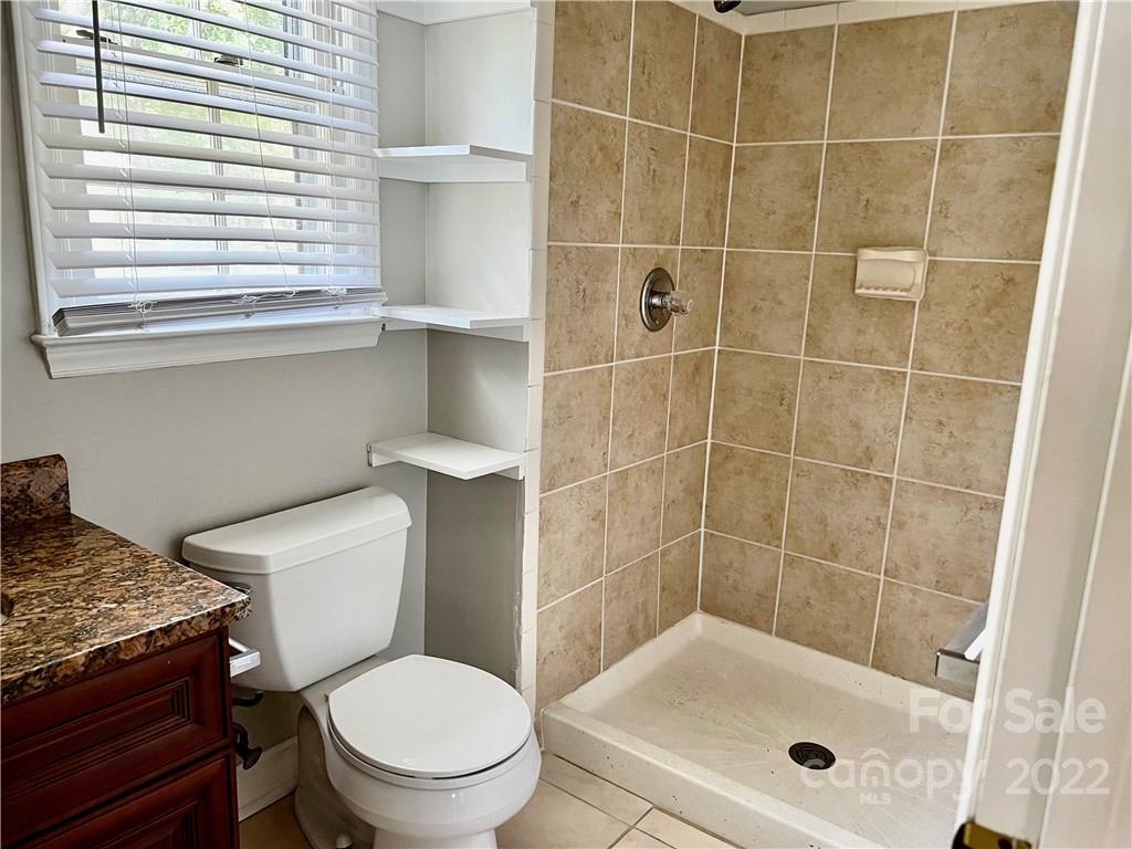 5736 Trotters Ridge Road Charlotte, NC 28227 - Photo 8 of 18 a white toilet sitting next to a bathroom sink