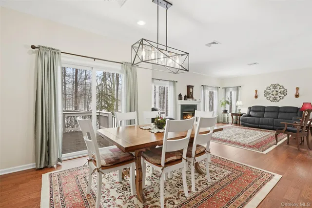 a dining room with furniture a rug and wooden floor