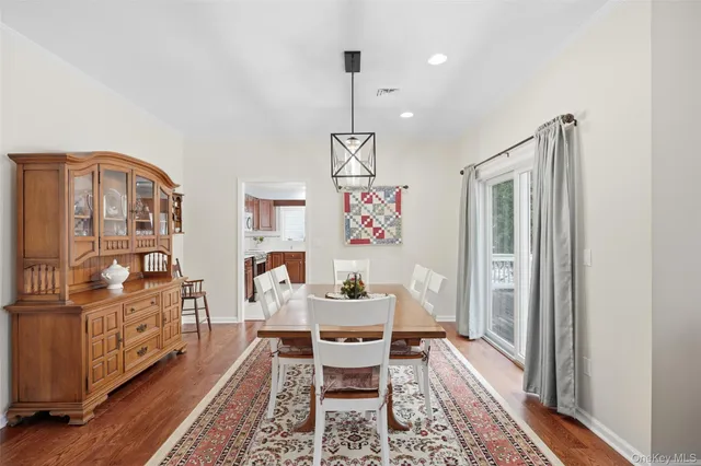 a workspace with furniture wooden floor a rug and a chandelier