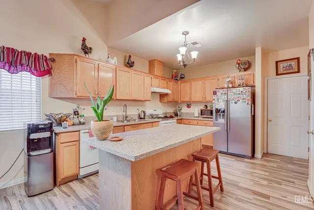 a kitchen with a stove a refrigerator and a dining table