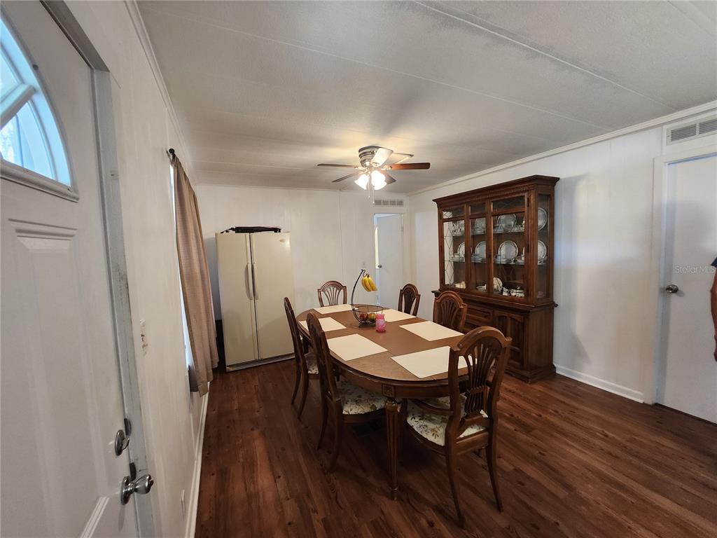 6091 Southeast 114th Street Road Belleview, FL 34420 - Photo 12 of 44 a view of a dining room with furniture and wooden floor