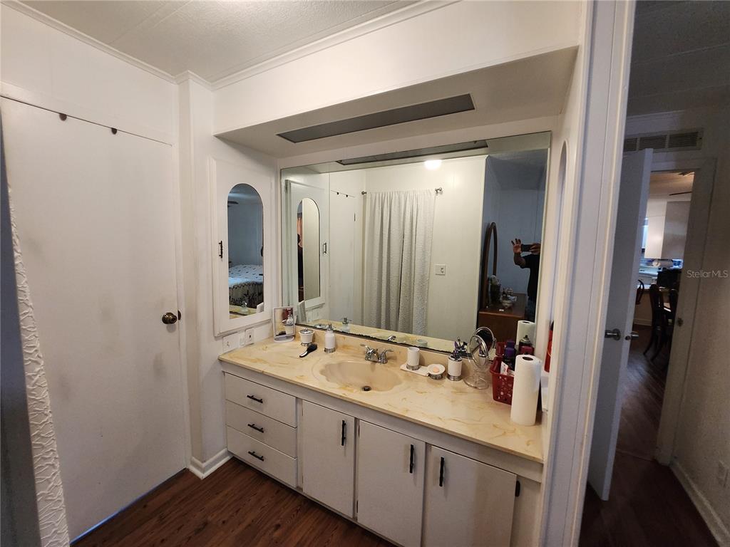 6091 Southeast 114th Street Road Belleview, FL 34420 - Photo 14 of 44 a bathroom with a double vanity sink and mirror