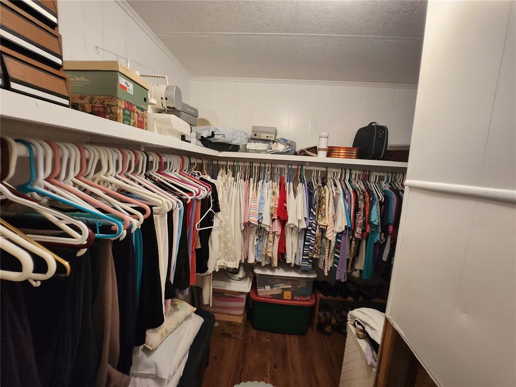 6091 Southeast 114th Street Road Belleview, FL 34420 - Photo 15 of 44 a view of walk in closet with clothes and shoes