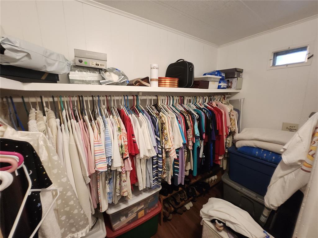 6091 Southeast 114th Street Road Belleview, FL 34420 - Photo 16 of 44 a view of walk in closet with clothes and shoes