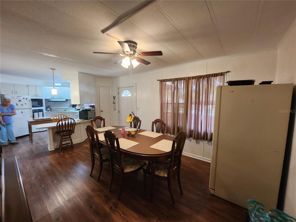 6091 Southeast 114th Street Road Belleview, FL 34420 - Photo 17 of 44 a view of a dining room with furniture and a chandelier
