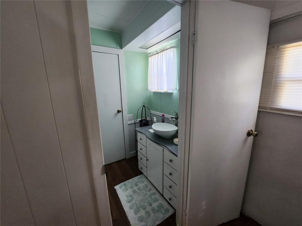 6091 Southeast 114th Street Road Belleview, FL 34420 - Photo 20 of 44 a bathroom with a sink a toilet and window