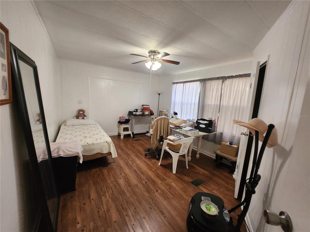 6091 Southeast 114th Street Road Belleview, FL 34420 - Photo 28 of 44 a living room with furniture a flat screen tv and a window