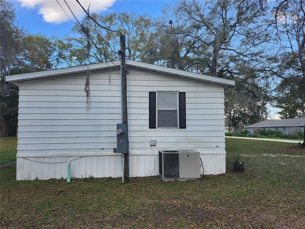 6091 Southeast 114th Street Road Belleview, FL 34420 - Photo 41 of 44 a view of a house with a yard