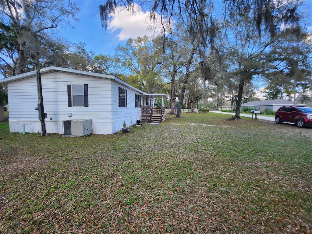 6091 Southeast 114th Street Road Belleview, FL 34420 - Photo 44 of 44 a view of a house with a yard