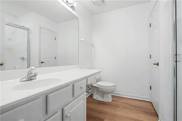 a bathroom with a sink toilet a mirror and vanity