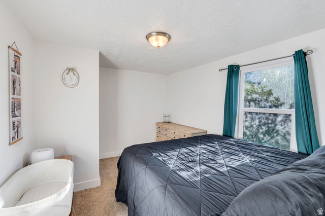 358 400 South Provo, UT 84601 - Photo 7 of 34 Carpeted bedroom with baseboards and a textured ceiling.