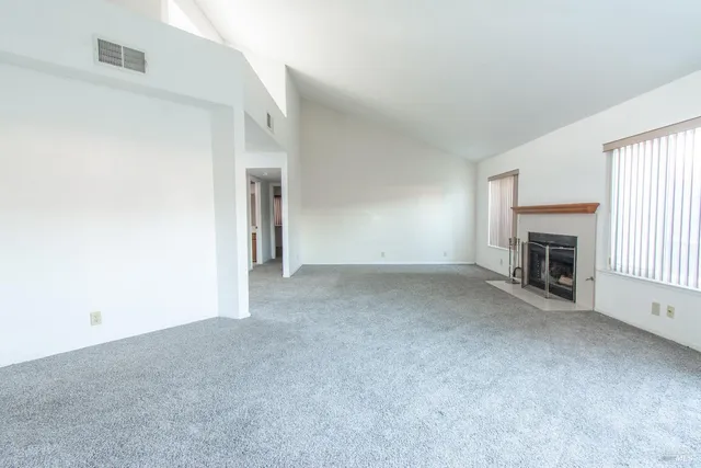 a view of empty room with a fireplace
