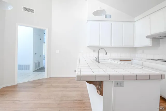 a kitchen with a sink cabinets and appliances