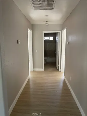 a view of hallway with wooden floor