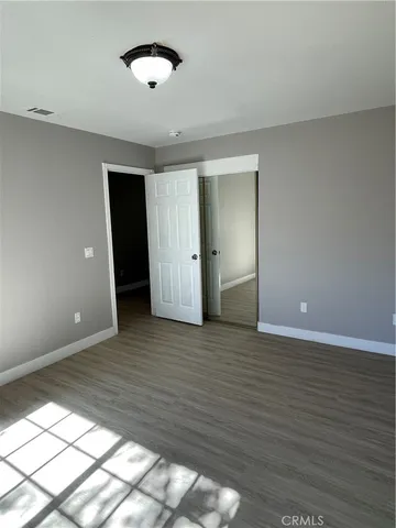a view of an empty room and wooden floor