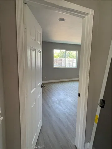 a view of hallway with wooden floor