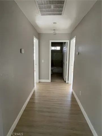 a view of a room with wooden floor and white walls