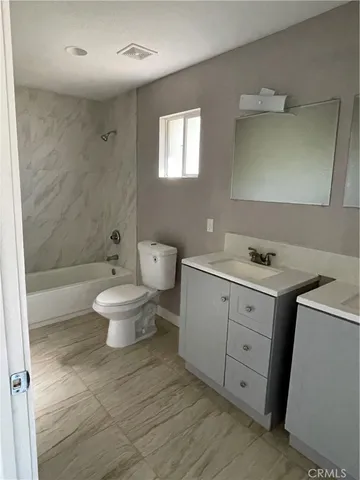 an empty room with wooden floor and a door