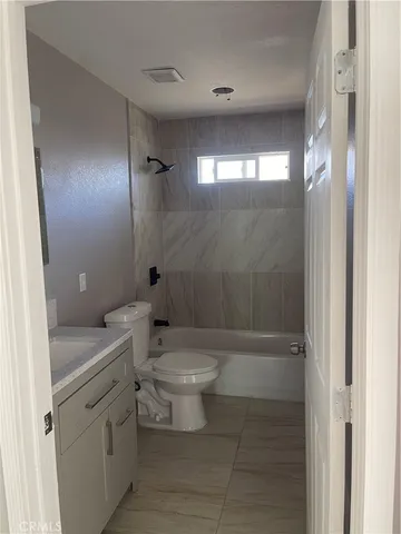 a white toilet sitting next to a bathroom sink