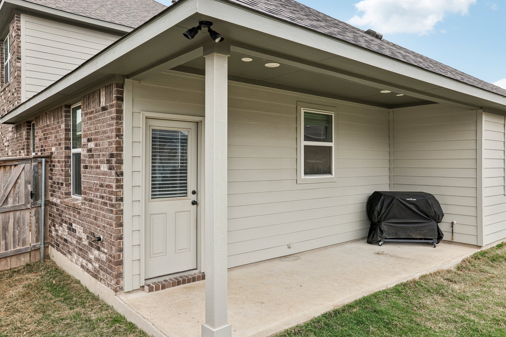 204 Swinging H Lane Georgetown, TX 78633 - Photo 33 of 39 Outdoor patio area featuring a concrete slab, a covered ceiling with recessed lighting, and an exterior door with blinds