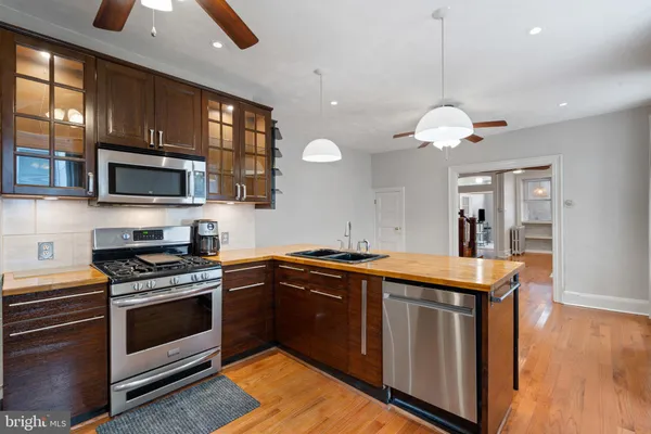a kitchen with stainless steel appliances granite countertop a stove and a microwave